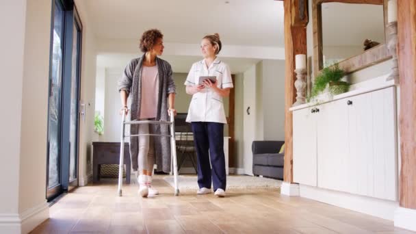 Mature Woman Dressing Gown Using Walking Frame Being Helped Female — Stock Video