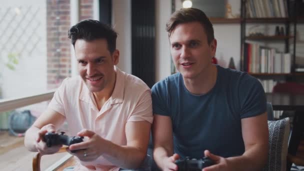 Same Sex Male Couple Sitting Sofa Home Playing Computer Game — Stock Video