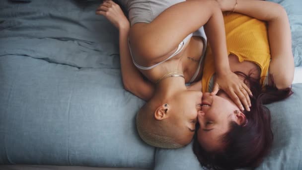 Overhead Shot Loving Same Sex Couple Lying Bed Home Holding — Stok Video