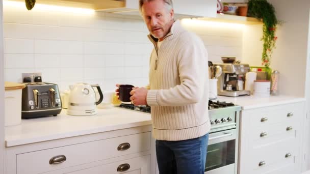 Mature Man Home Kitchen Makes Coffee Looking Digital Tablet Shot — Stockvideo