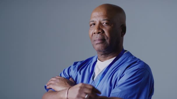 Studio Portrait Mature Male Nurse Wearing Scrubs Grey Background Shot — Stock Video