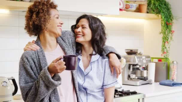 Loving Gay Mature Female Couple Wearing Pyjamas Hugging Kitchen Home — Stock Video