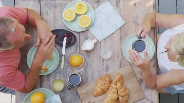 Top Shot Retired Senior Couple Outdoors Deck Home Eating Breakfast — Stock Video