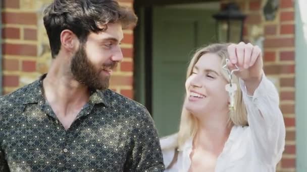 Portrait Excited Couple Holding Keys New Home Standing Front Door – Stock-video