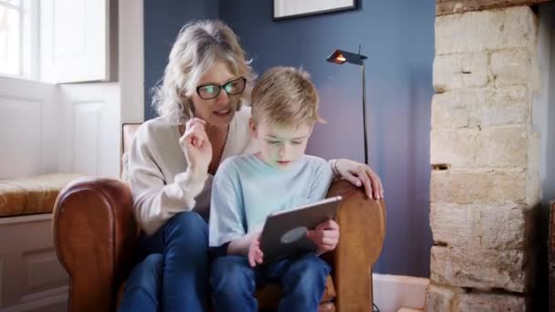 Grandmother Grandson Home Sitting Armchair Using Digital Tablet Together — 图库视频影像