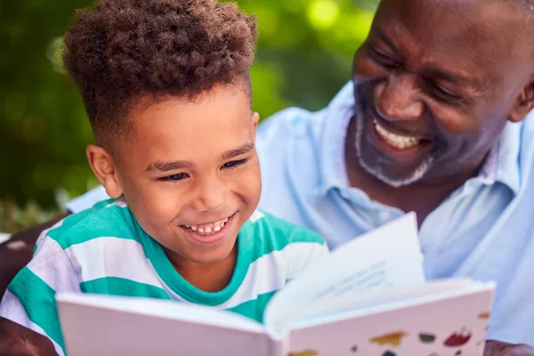 Grandfather Sitting Outdoors Grandson Home Reading Book Together — Stock Photo, Image