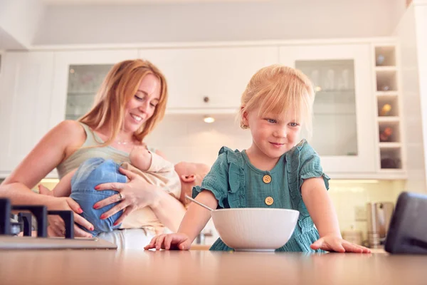 Chica Mostrador Cocina Comiendo Desayuno Viendo Teléfono Móvil Mientras Madre —  Fotos de Stock