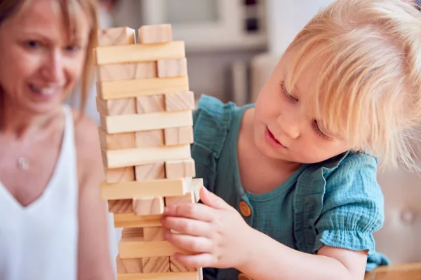 Mother Daughter Having Fun Sitting Table Playing Game Building Tower — Stock Photo, Image