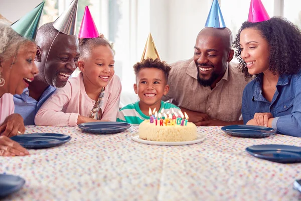 Flergenerationsfamilj Sitter Runt Bordet Hemma Och Firar Pojkens Födelsedag Med — Stockfoto