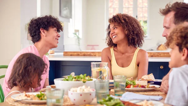 Family Sitting Table Home Eating Meal Together — Stock Photo, Image