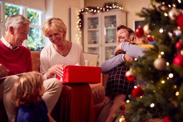 Mehrgenerationenfamilie Tauscht Geschenke Rund Den Weihnachtsbaum Hause Aus — Stockfoto