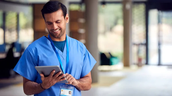 Мужчина Медицинский Работник Scrubs Цифровыми Таблетками Больнице — стоковое фото