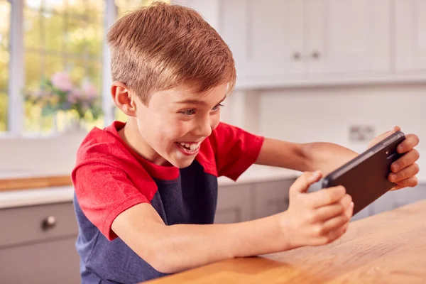 Excited Boy Home Kitchen Playing Game Mobile Phone — Stock Photo, Image