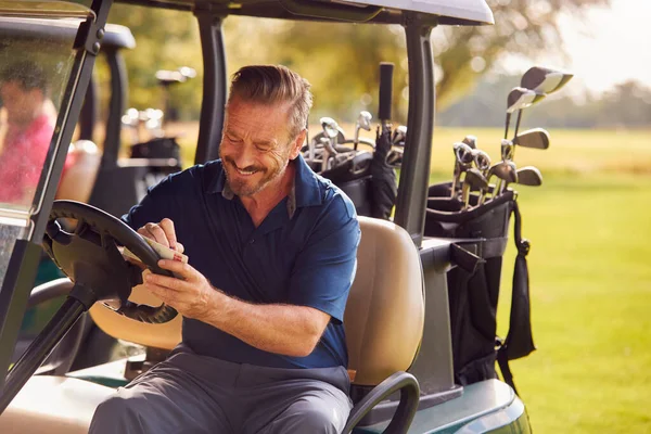 Hombre Maduro Sentado Buggy Jugando Golf Chequeando Tarjeta Puntuación —  Fotos de Stock