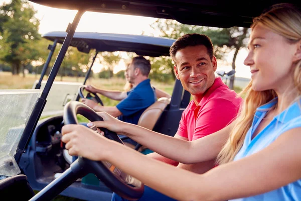 Mature Mid Adult Couples Driving Buggies Playing Golf Together — Stock Photo, Image