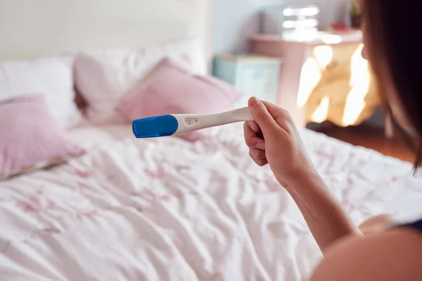 Close Adolescente Sentada Cama Casa Olhando Para Teste Gravidez Positiva — Fotografia de Stock