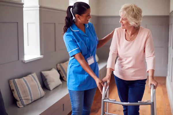 Senior Woman Home Using Walking Frame Being Helped Female Care — Foto de Stock