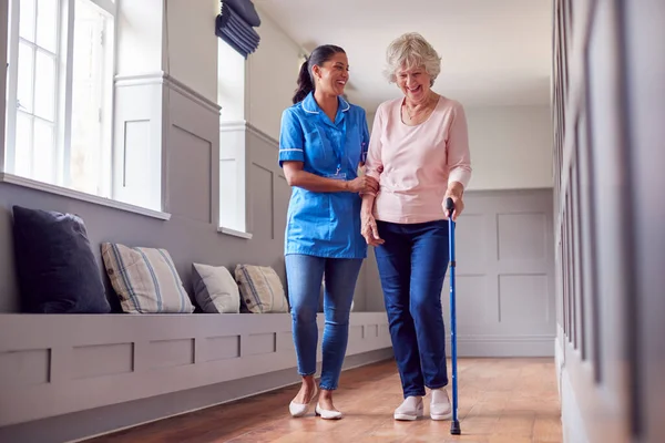 Senior Woman Home Using Walking Stick Being Helped Female Care — Stock fotografie