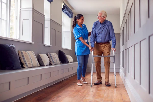 Senior Man Home Using Walking Frame Being Helped Female Care — Stock fotografie