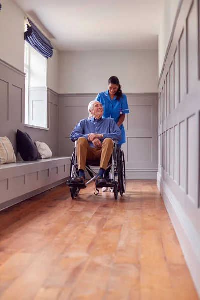 Senior Man Home Being Pushed Wheelchair Female Care Worker Uniform — Stok fotoğraf