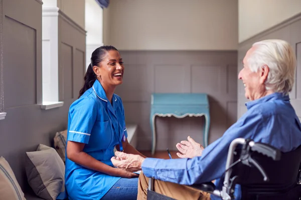 Senior Man Home Wheelchair Talking Female Care Worker Uniform — Fotografia de Stock