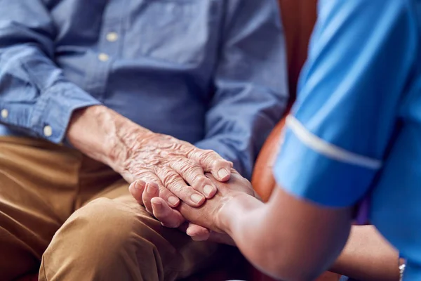 Close Female Care Worker Uniform Holding Hands Senior Man Sitting — Stok fotoğraf