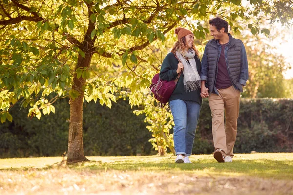 Happy Loving Couple Holding Hands Walking Autumn Park Together — Fotografia de Stock