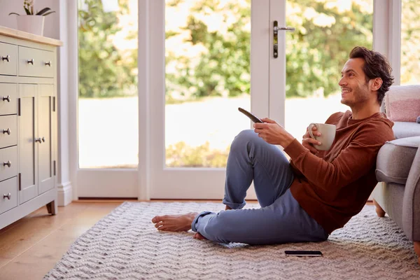 Man Home Sitting Floor Remote Control Watching — Stockfoto