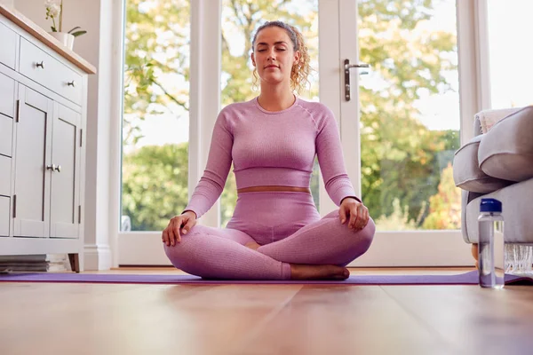 Young Woman Mat Home Doing Yoga Exercises — Stockfoto