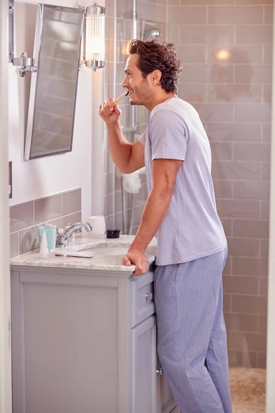 Man Wearing Pyjamas Bathroom Brushing Teeth Sustainable Wooden Toothbrush — Stok fotoğraf