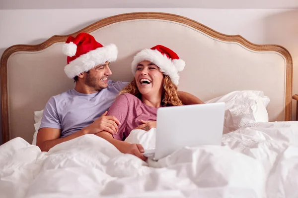 Couple Christmas Lying Bed Home Making Video Call Laptop Wearing — Fotografia de Stock
