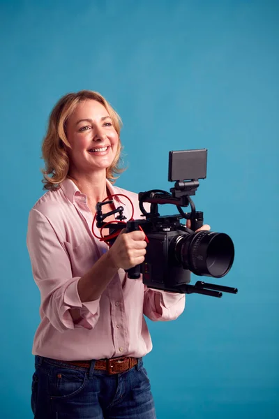 Mature Female Videographer Camera Filming Video Blue Background Shoot Studio — Stock fotografie