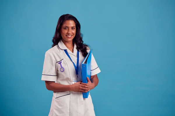 Portrait Smiling Female Mature Nurse Wearing Uniform Standing Front Blue — Stockfoto