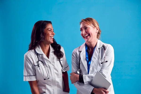 Mature Doctor Nurse Wearing White Coat Laughing Talking Front Blue — стоковое фото