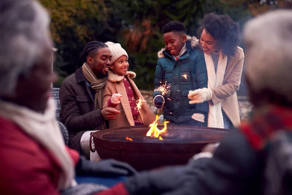 Multi Generation Family Having Fun Firework Sparklers Autumn Garden Together — Fotografia de Stock