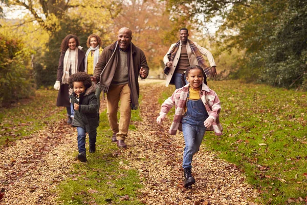 Smiling Multi Generation Family Having Fun Children Walking Autumn Countryside — Fotografia de Stock