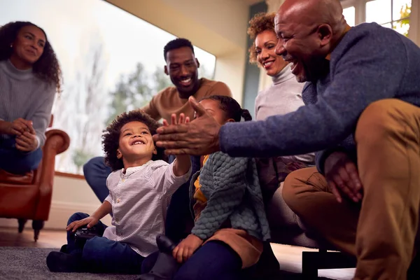 Multi Generation Family Having Fun Playing Video Game Lounge Home — Stockfoto