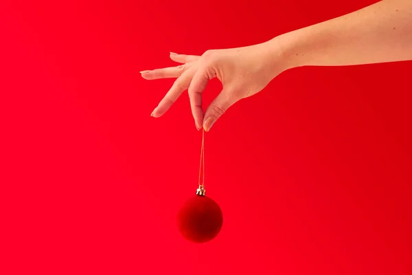 Close Studio Shot Woman Holding Christmas Tree Decoration Red Background — стоковое фото