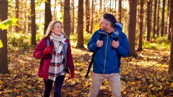 Side View Mature Retired Couple Backpacks Walking Fall Winter Countryside — стоковое фото