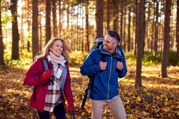 Side View Mature Retired Couple Backpacks Walking Fall Winter Countryside — стоковое фото