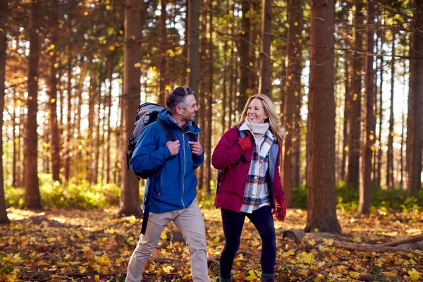 Mature Retired Couple Backpacks Walking Fall Winter Countryside — стоковое фото