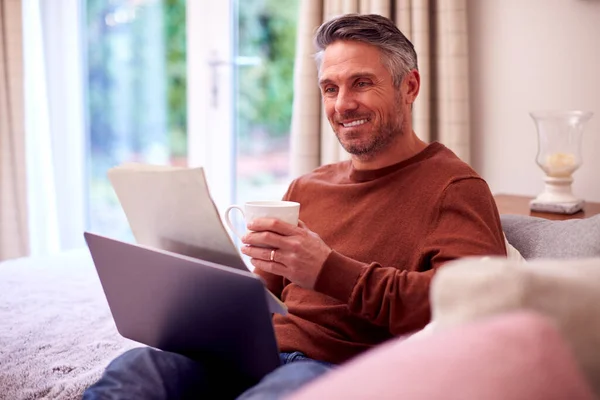 Mature Man Home Sitting Sofa Laptop Looking Personal Finance Documents — Photo