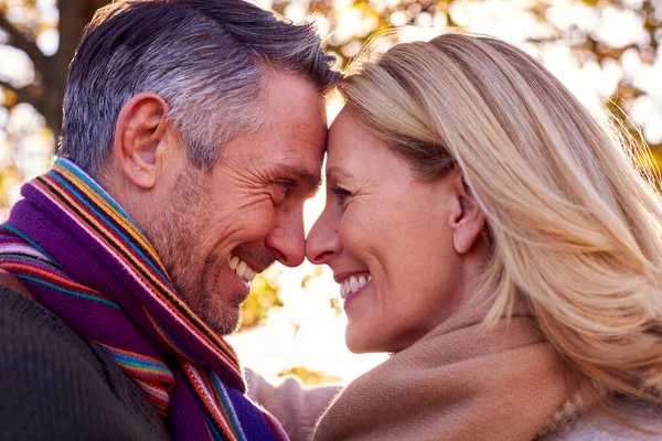 Loving Mature Retired Couple Hugging Autumn Countryside Flaring Sun — Foto Stock