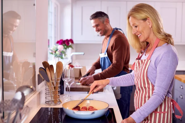 Mature Couple Home Kitchen Chopping Ingredients Cooking Pan Prepare Meal — Fotografia de Stock