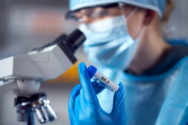 Female Lab Research Worker Wearing Ppe Holding Test Tube Labelled — Stock Photo, Image