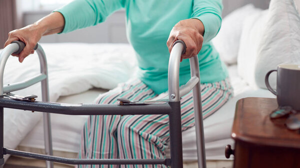 Close Senior Woman Home Using Walking Frame Get Out Bed Stock Picture