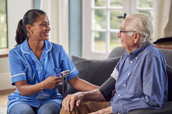 Senior Man Home Lounge Having Blood Pressure Taken Female Care Stock Image