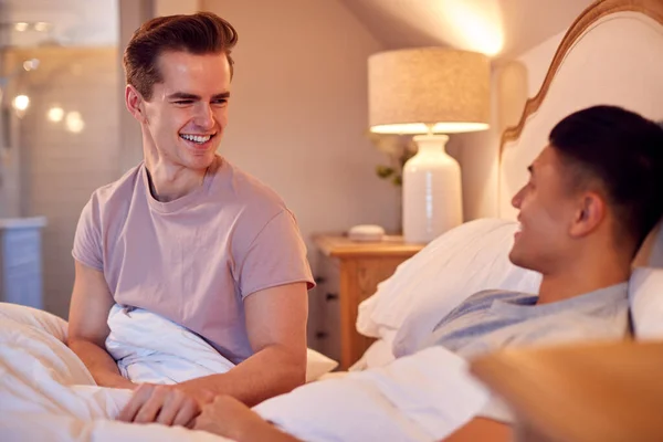 Loving Same Sex Male Couple Lying Bed Home Holding Hands — Foto de Stock