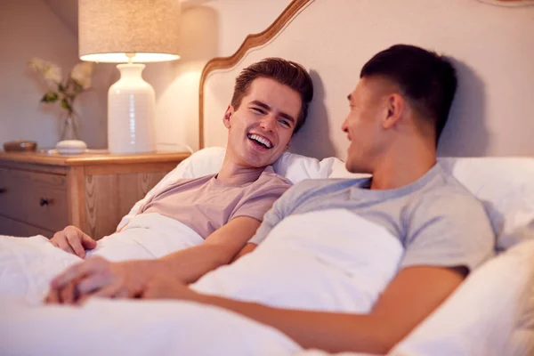 Loving Same Sex Male Couple Lying Bed Home Holding Hands — Foto de Stock