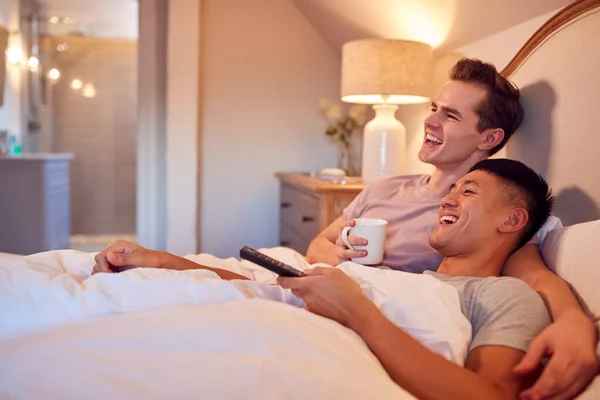 Loving Same Sex Male Couple Lying Bed Home Watching Together — Stok fotoğraf